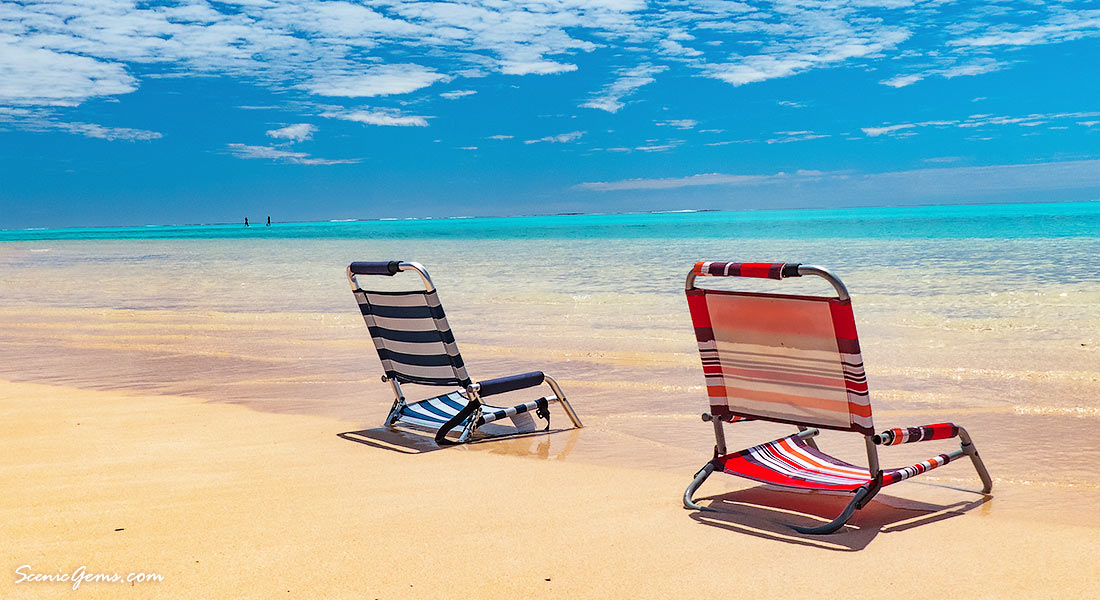 Empty beach chairs at the waters edge of Sandy Bay, Cape Range National Park, Exmouth, Western Australia