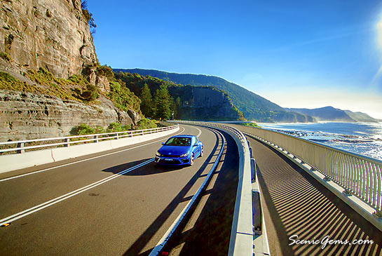 Car driving along the Sea Cliff Bridge, Coalcliff NSW, Australia