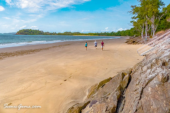 Walkers on the beach of Lugger Bay, South Mission Beach, Queensland, Australia