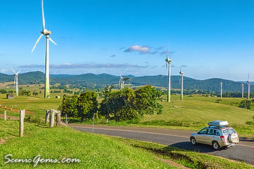 Car driving by Windy Hill Wind Farm, Atherton Tablelands, Queensland, Australia